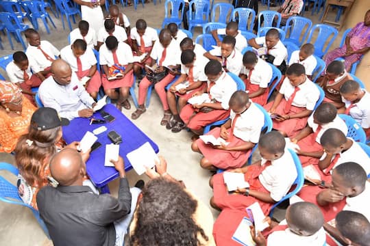 Book reading session organised by a mentor Barr. Ini Ememobong with students of his adopted school
