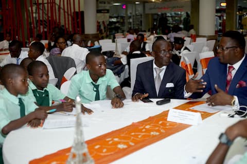 Students of Comprehensive Secondary School Oboetim being mentored by a representative of Michael & Harrison Foundation
