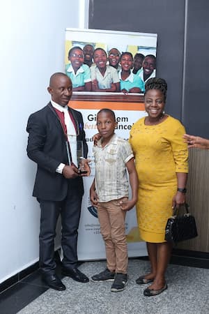 An Awardee, his spouse and child at the Annual Award's Event