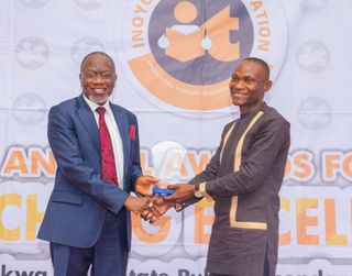 Emmanuel Okon, First Prize Winner, Chemistry, Receiving Award From Dr. Dominic Ukpong, Ssa to Gov. on Health; Rep of the Award Sponsor, Hensek ltd